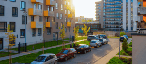 exterior view of an apartment building with side street guest parking in view