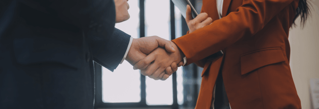 two people shaking hands in an office