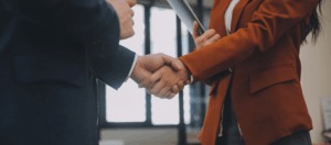 two people shaking hands in an office